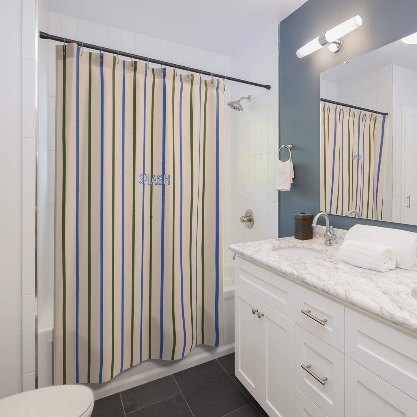 Bathroom with a patterned shower curtain, white vanity, and mirror.