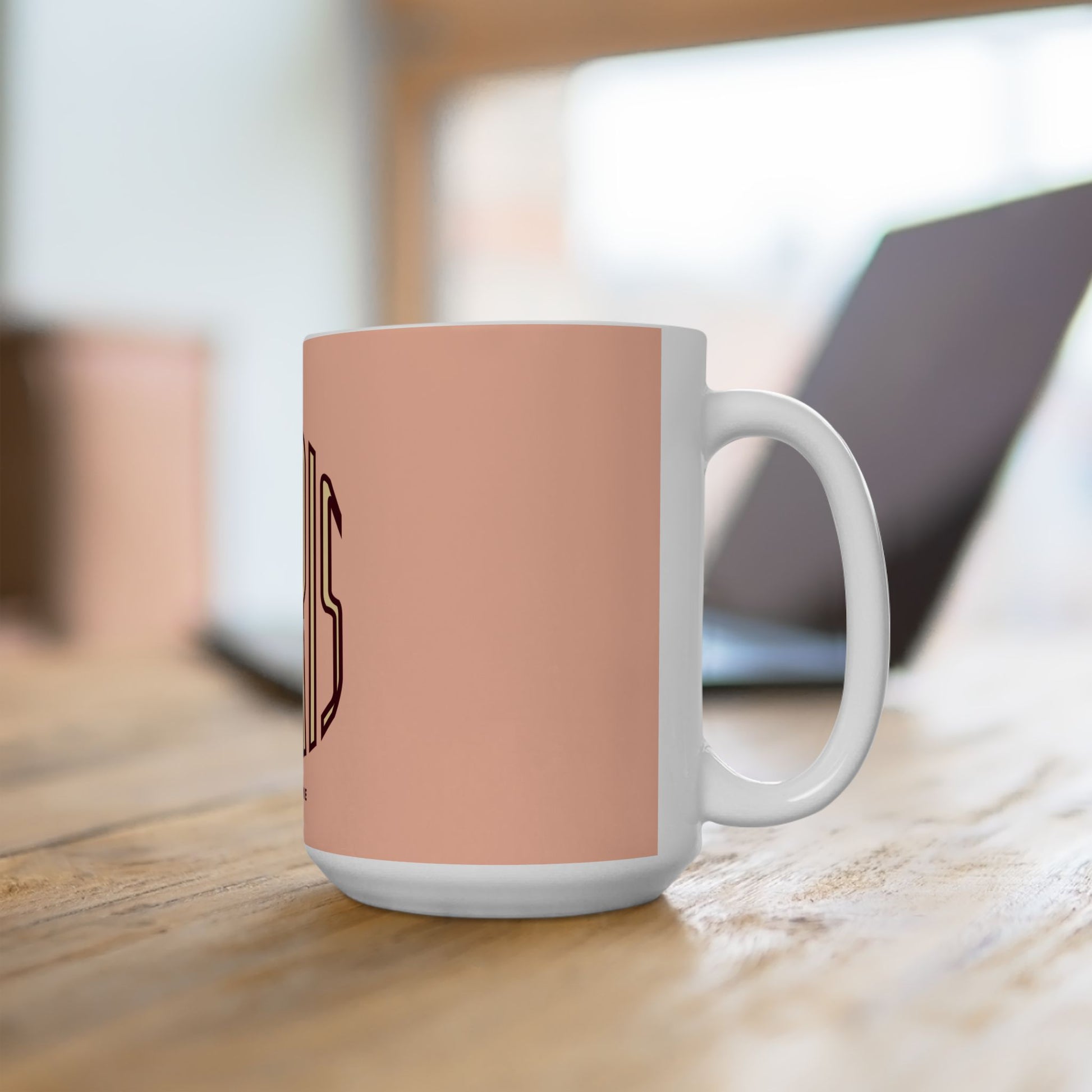 White mug with a pink accent on a wooden surface