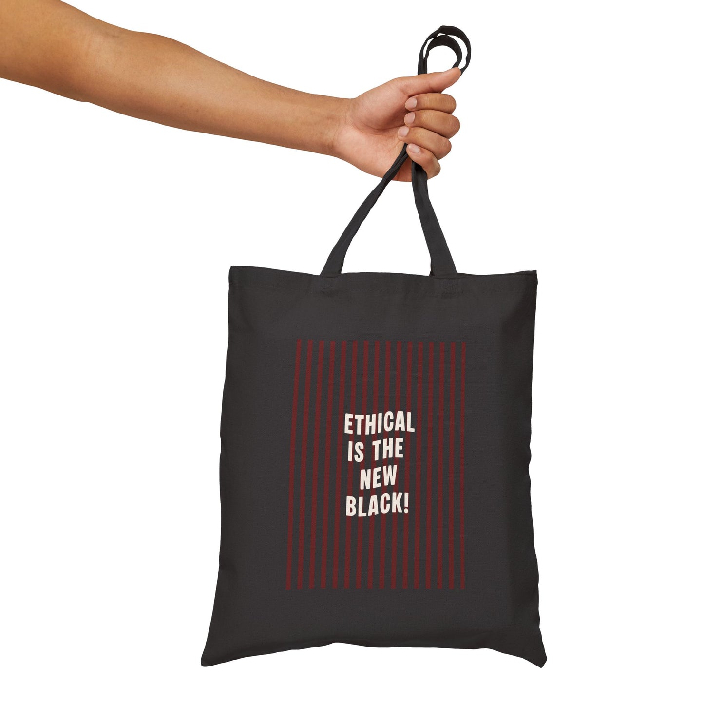 Black tote bag with 'Ethical is the New Black!' text held by a hand on a white background