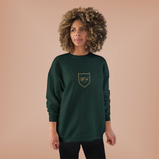 Woman wearing a green sweatshirt with OLD SOUL CLUB logo on a beige background