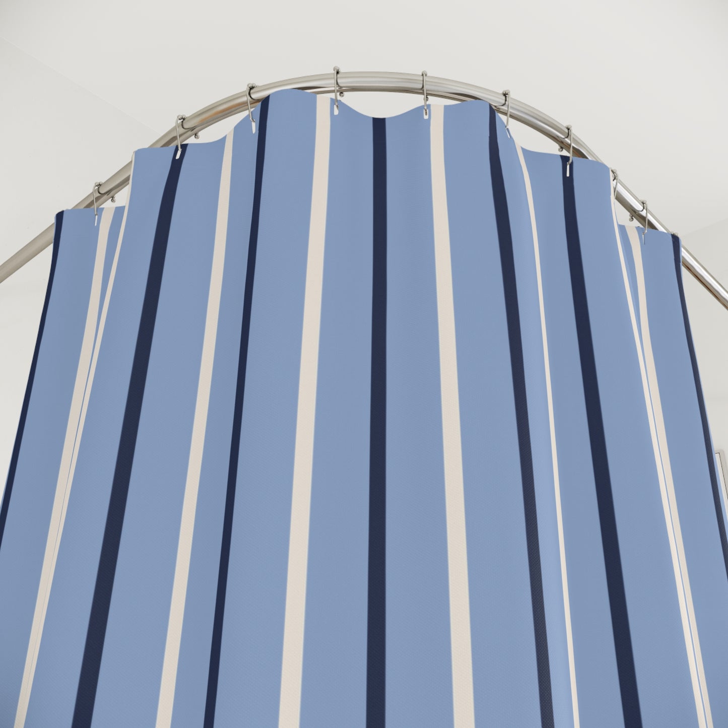 Blue and white striped shower curtain with a metal frame against a light gray background