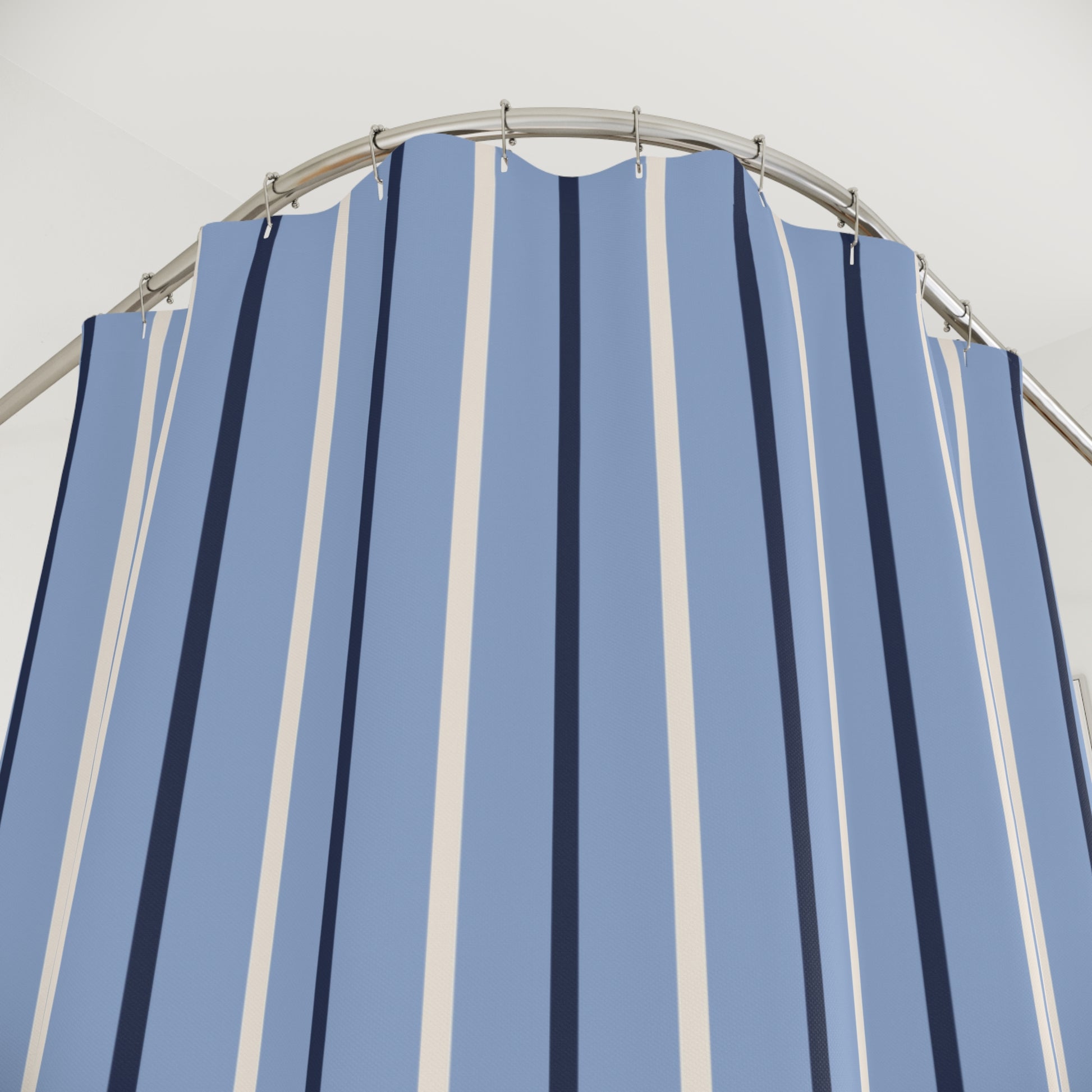 Blue and white striped shower curtain with a metal frame against a light gray background
