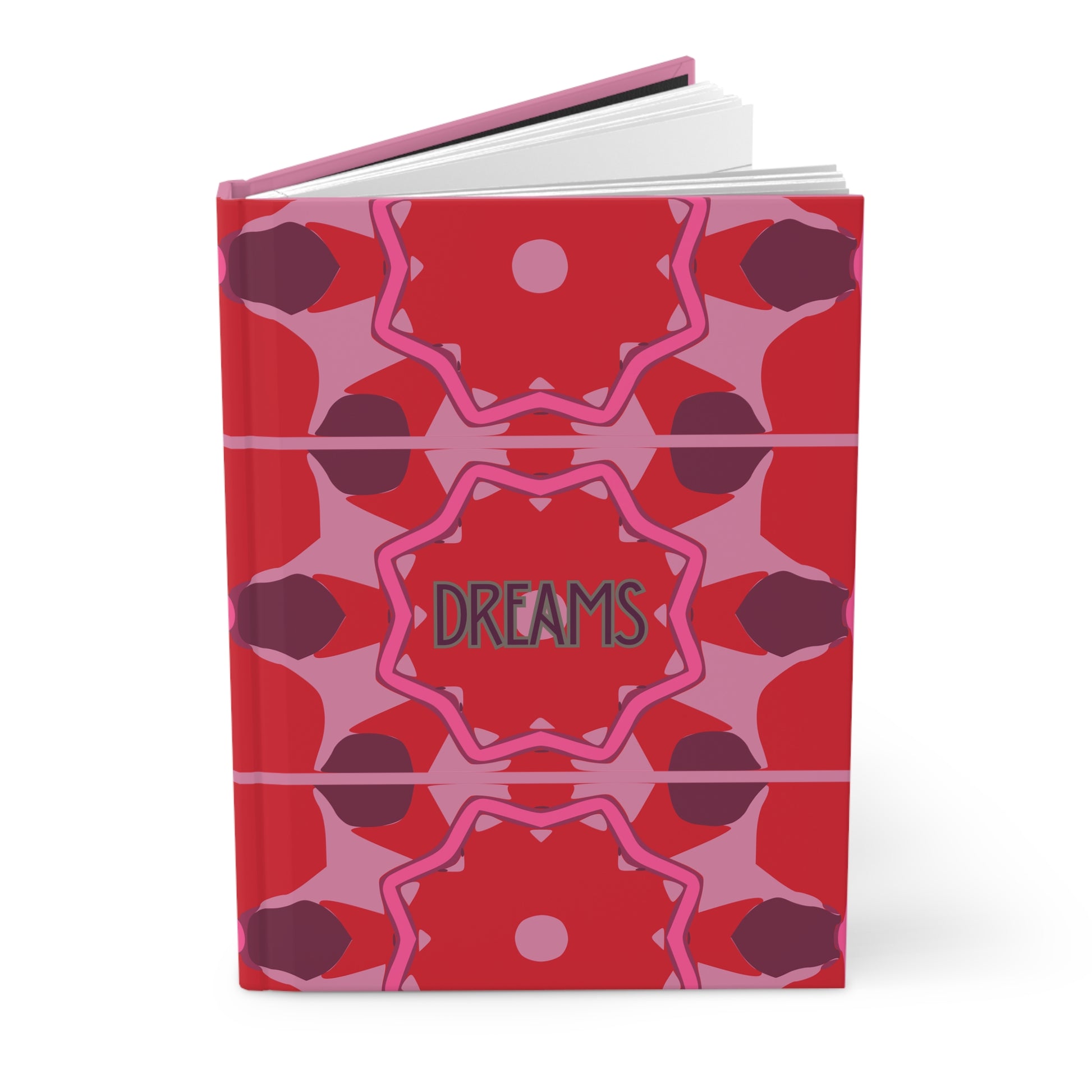 Notebook with red and pink geometric design on cover, featuring the word 'DREAMS'.