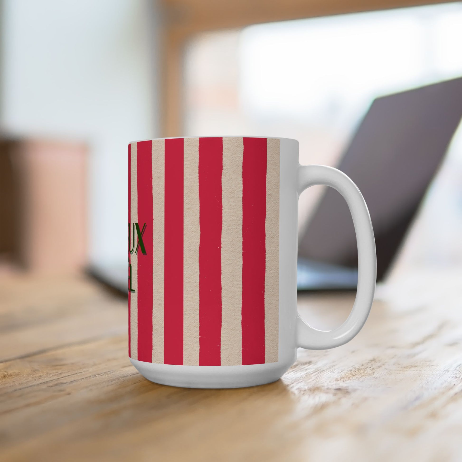 White mug with red and beige striped pattern on a wooden surface