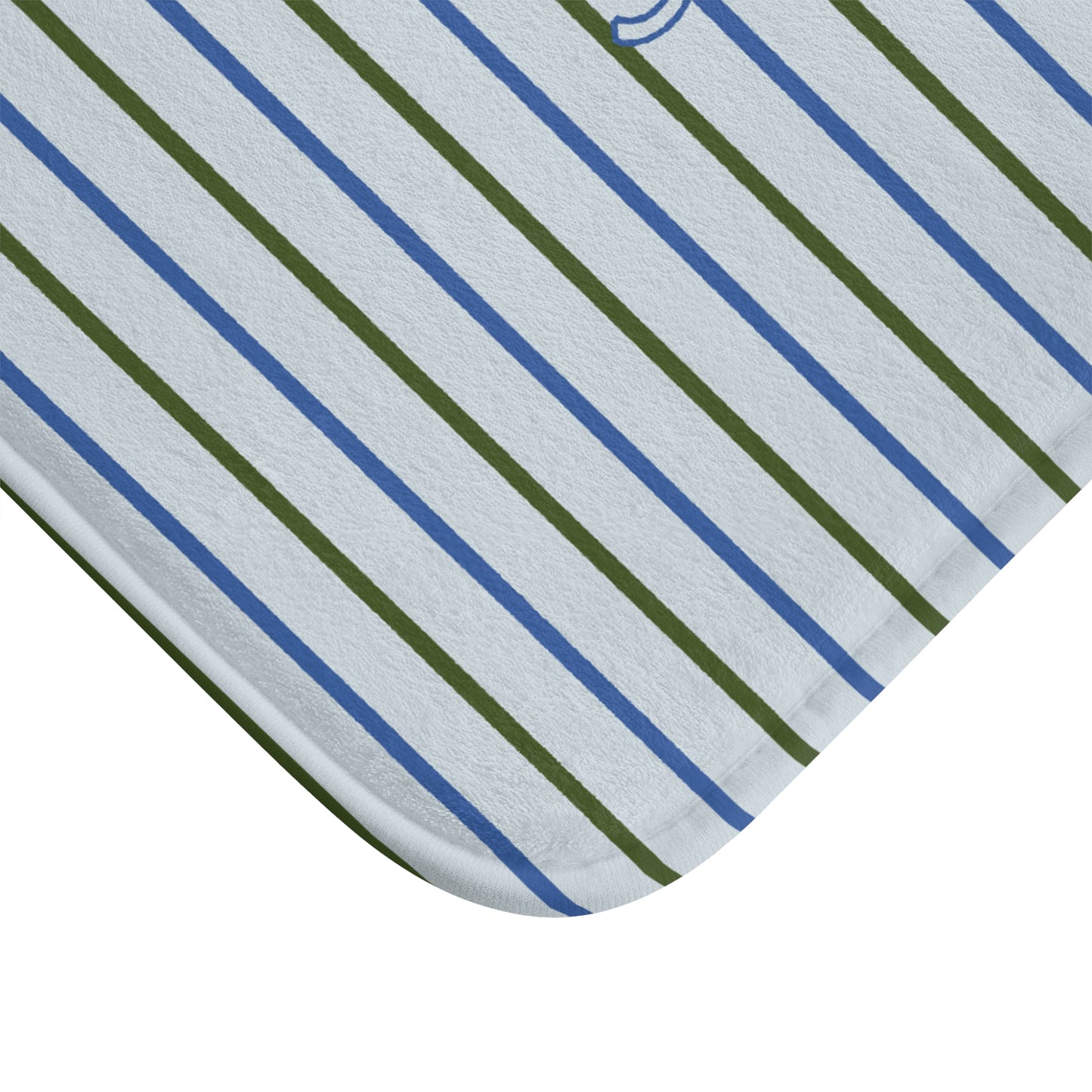 Close-up of a fabric with blue and green diagonal stripes on a light gray background