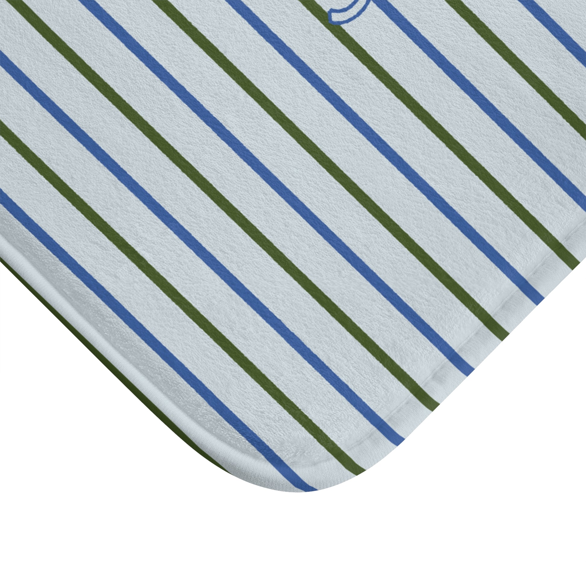Close-up of a fabric with blue and green diagonal stripes on a light gray background