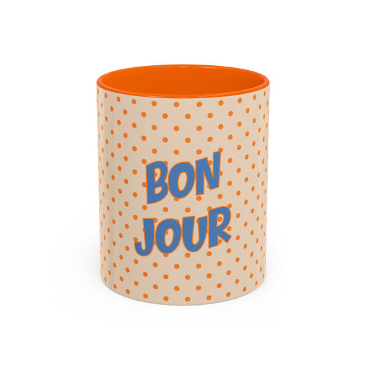 Mug with polka dot pattern and 'Bonjour' text on a white background