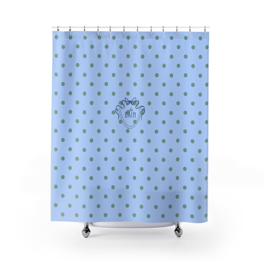 Blue shower curtain with green polka dots and a logo on a white background