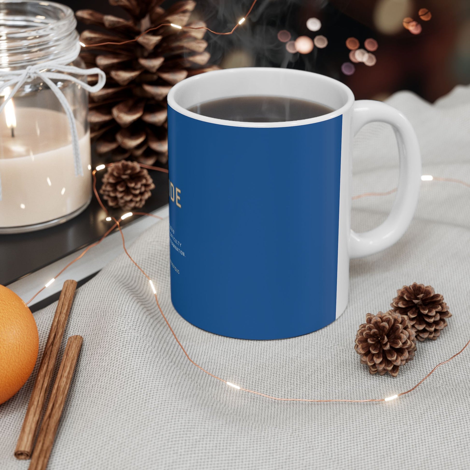 Blue mug with white handle on a table with decorative items