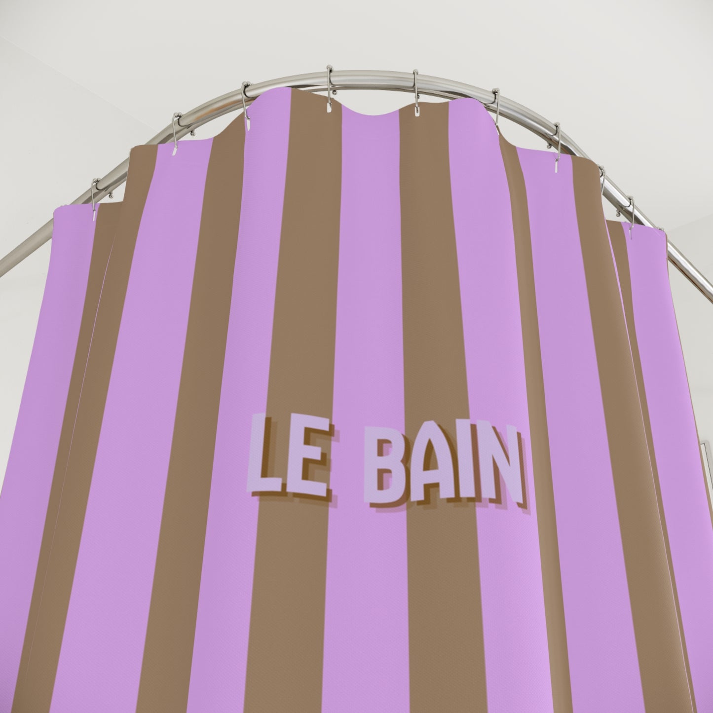 Striped shower curtain with 'LE BAIN' text on a metal rod against a white background
