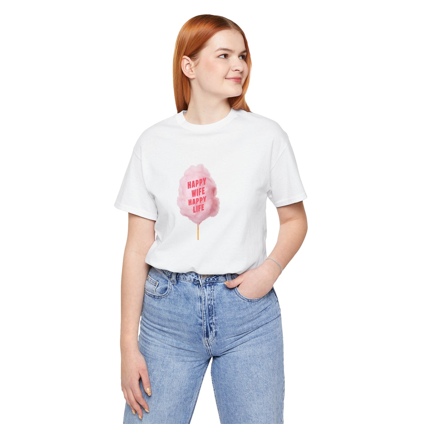 A woman with red hair wearing a white short-sleeve t-shirt with a pink cotton candy graphic on the front, paired with light blue jeans, against a plain white background.