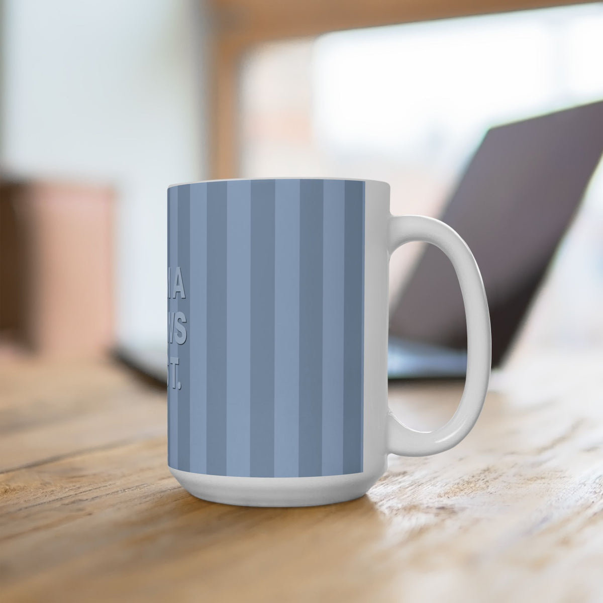 White mug with blue striped pattern on a wooden surface
