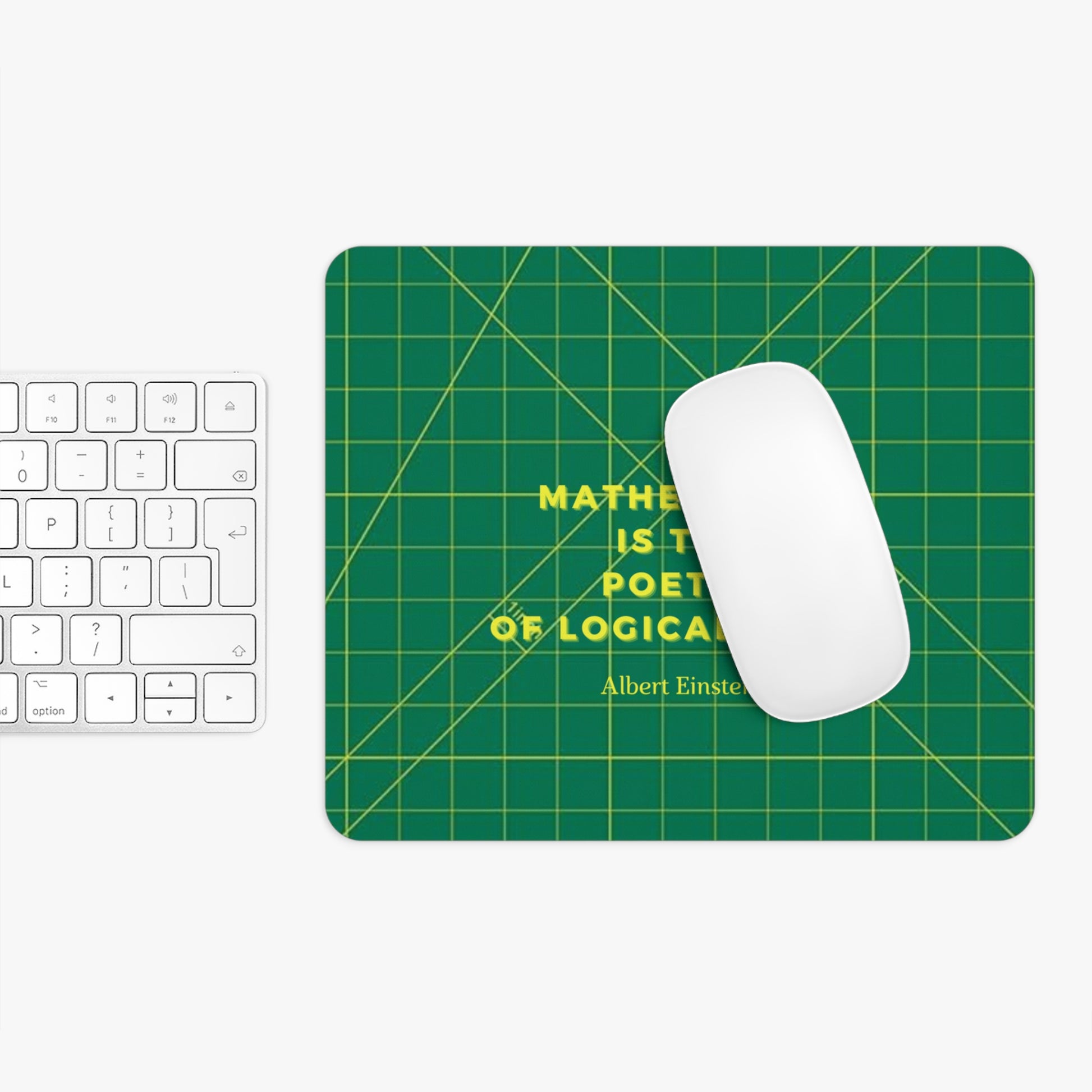 Green mouse pad with grid pattern and Einstein quote, placed on a white surface with a keyboard and mouse.