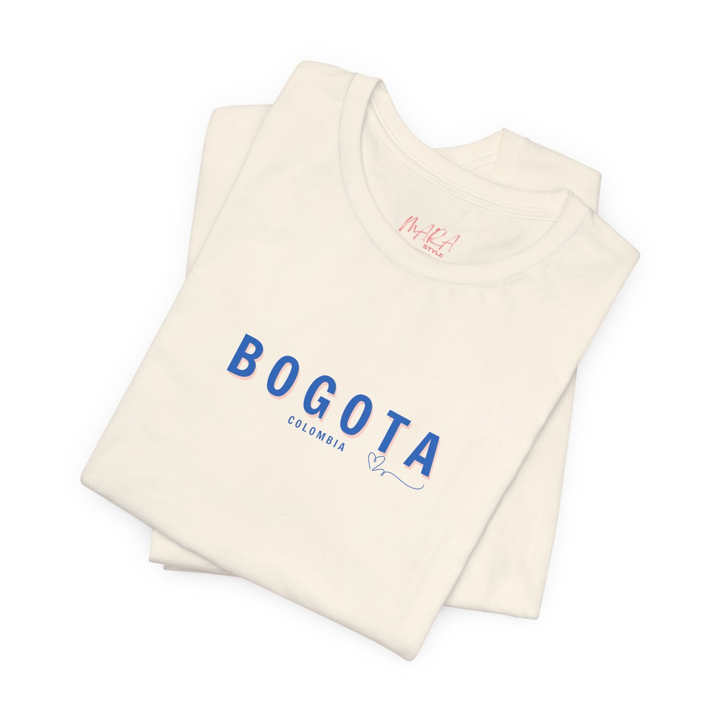 A pink Bogota unisex t-shirt with the word 'BOGOTA' written in blue letters across the front.