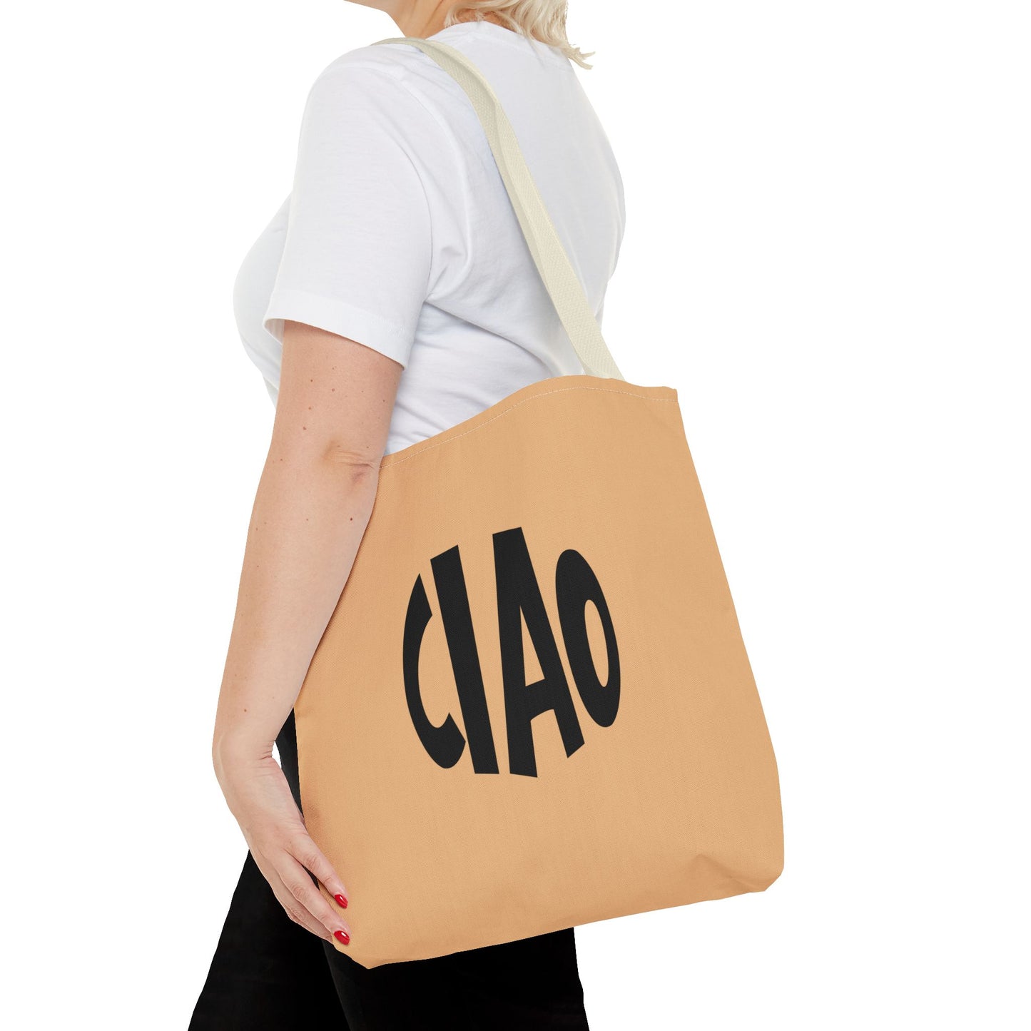 Person holding a tan tote bag with 'CIAO' printed on it against a white background