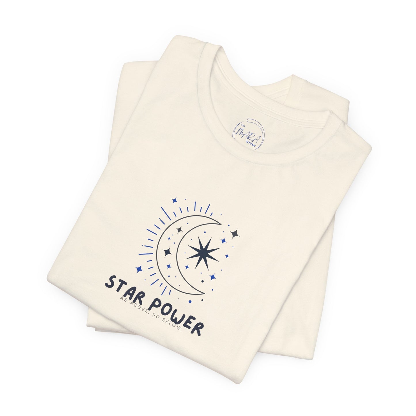 A folded cream-colored t-shirt with a dark blue graphic of a crescent moon, stars, and the text 'STAR POWER' on the front, displayed on a clean white background.