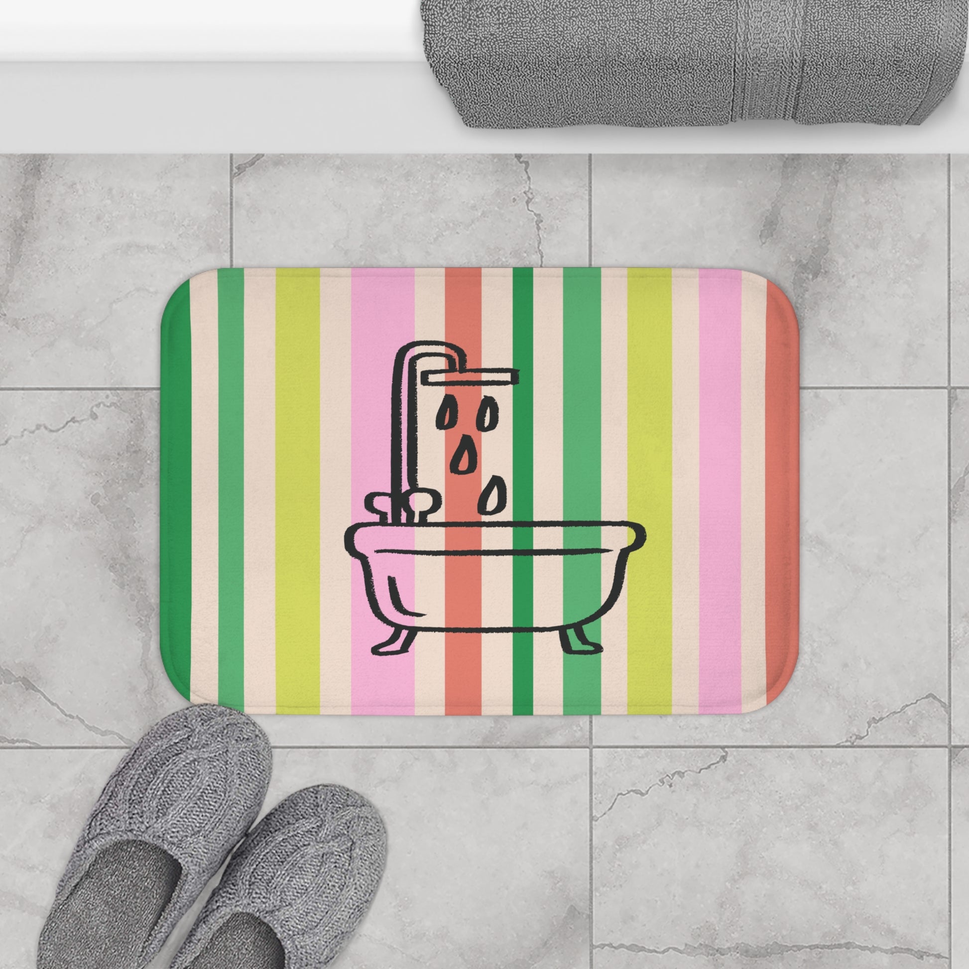 Striped bath mat with bathtub and shower design on a tiled floor.