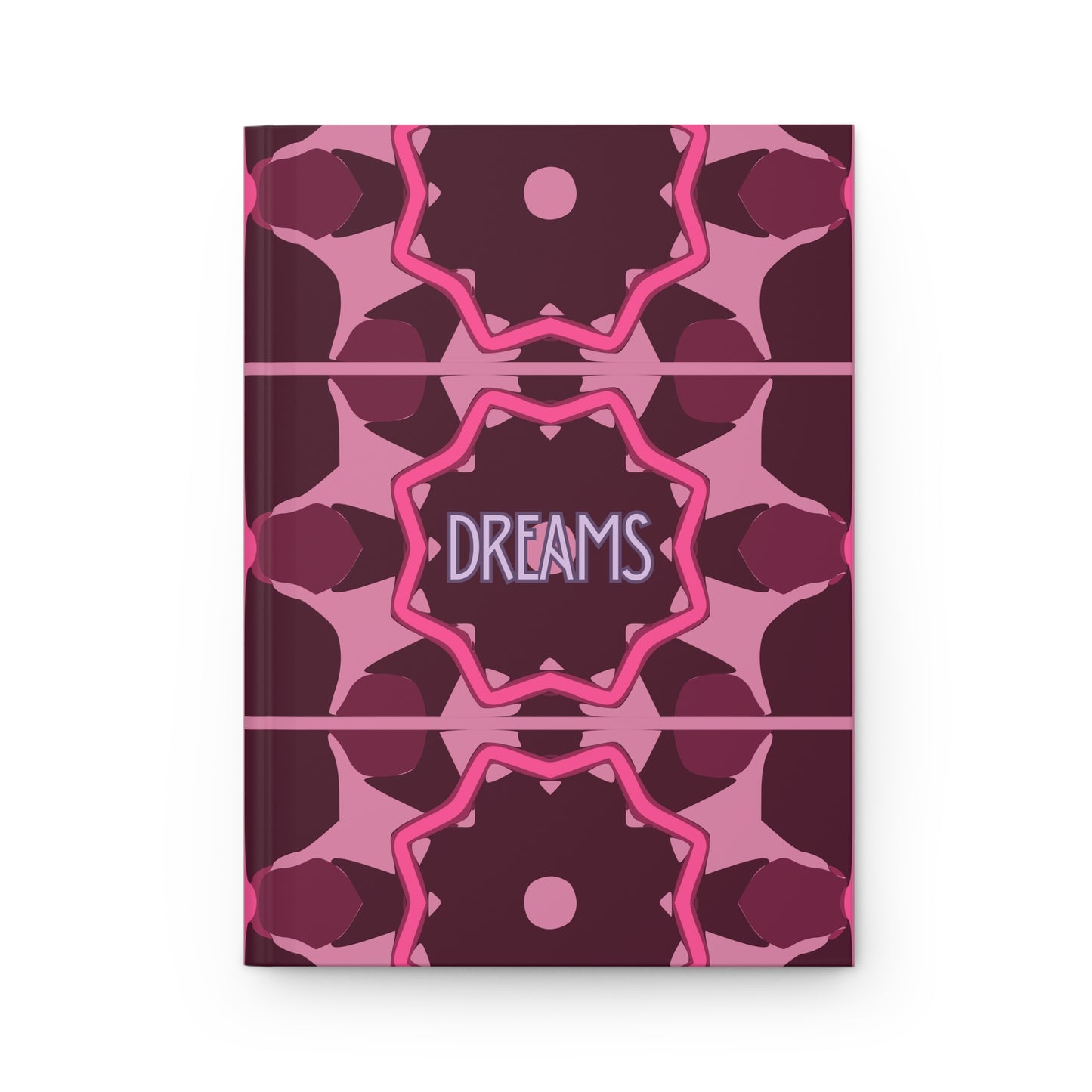 Notebook with pink and purple geometric pattern and 'DREAMS' text on a white background