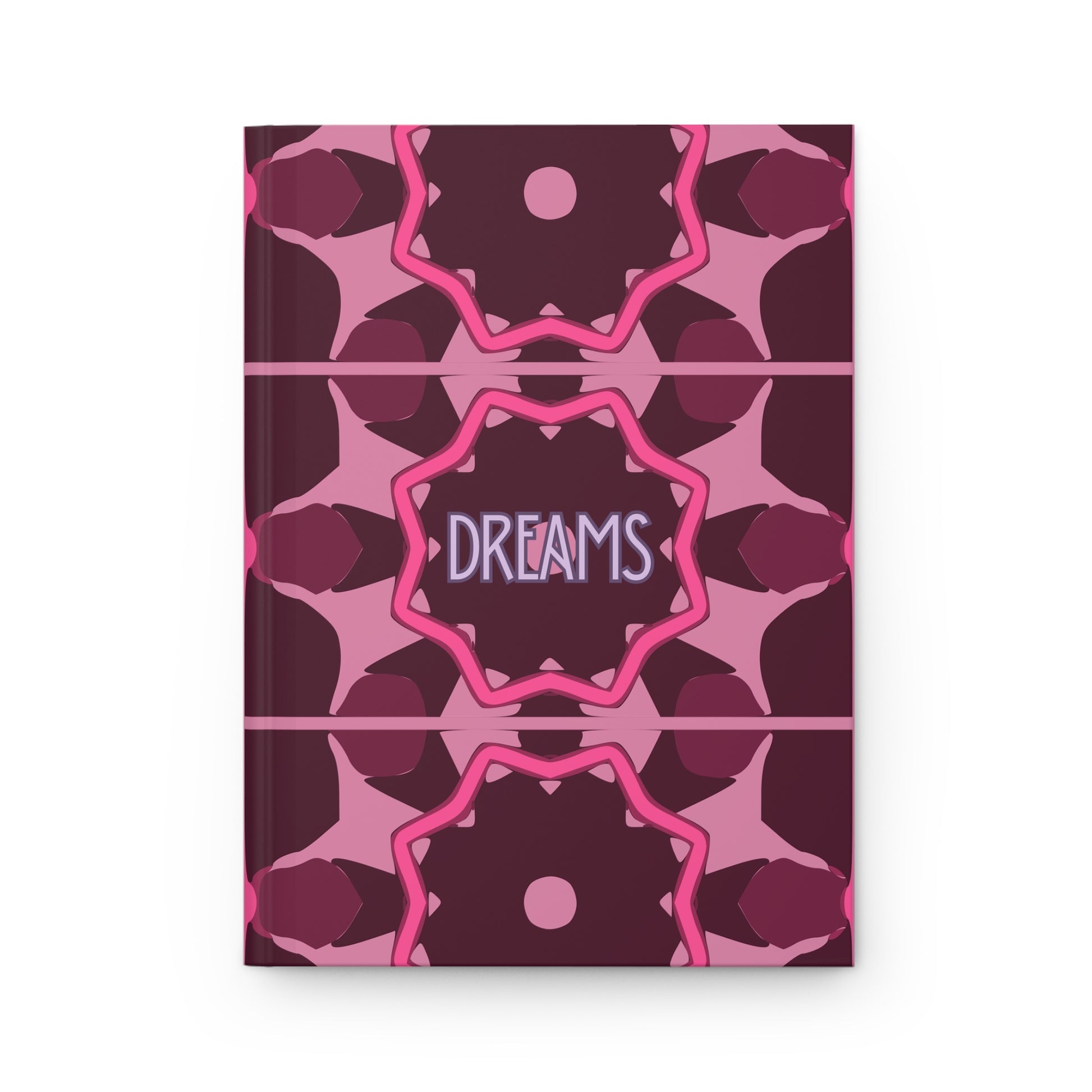 Notebook with pink and purple geometric pattern and 'DREAMS' text on a white background