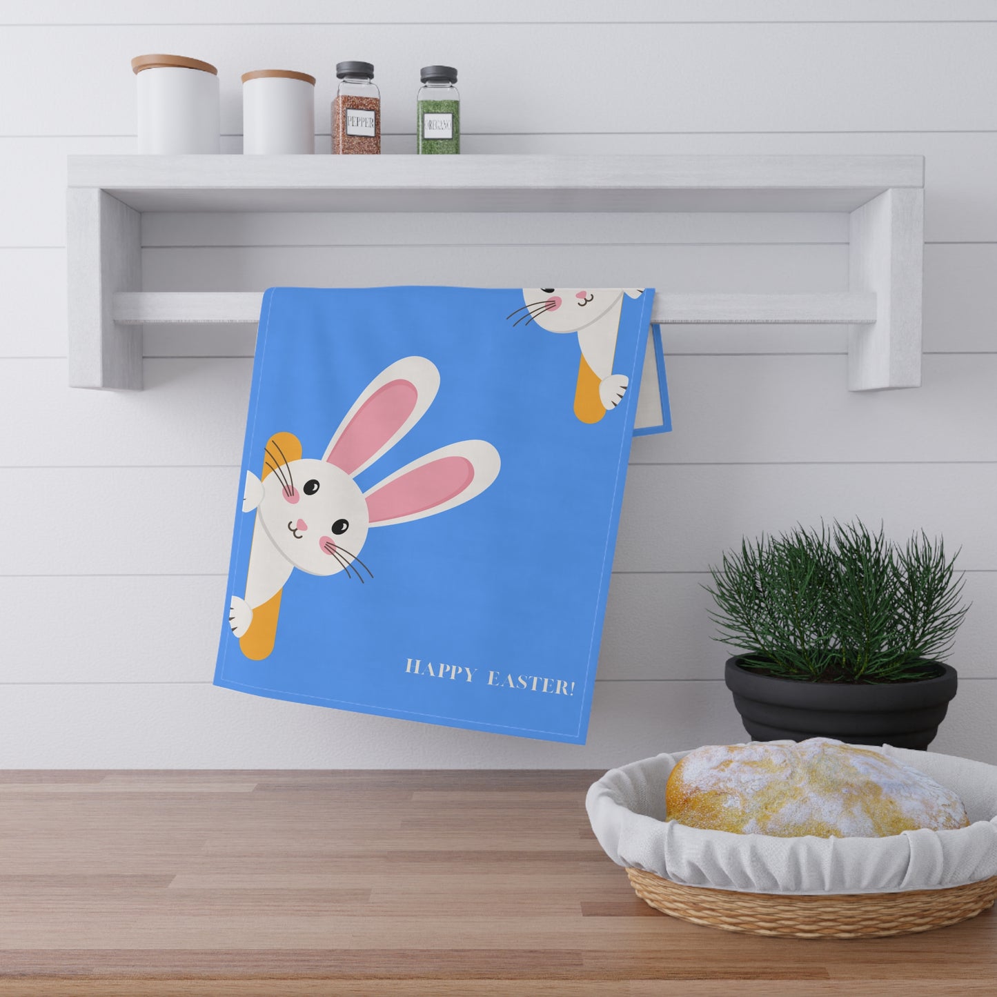 Blue towel with Easter bunny design on a kitchen counter