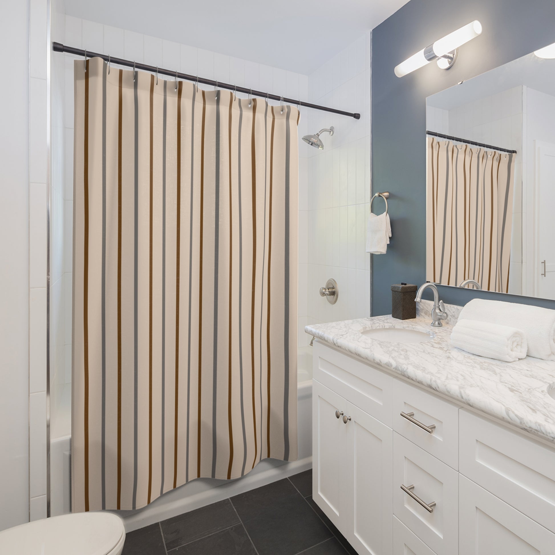 Bathroom with striped shower curtain, white vanity, and mirror.