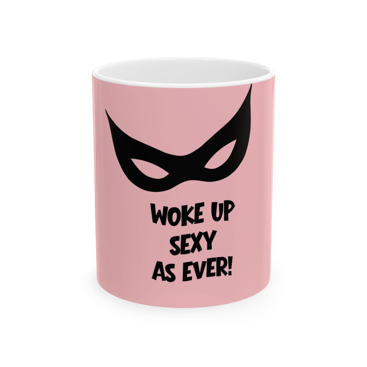 A pink ceramic mug with a black cat-eye mask graphic and the text 'WOKE UP SEXY AS EVER!' printed on the front, shown against a plain white background.