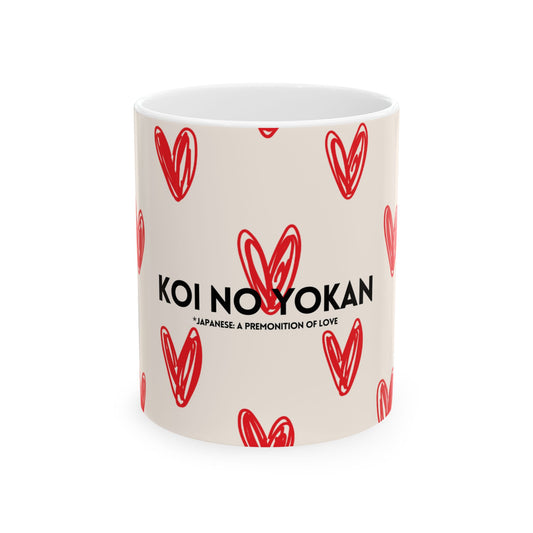A white ceramic mug with a red hand-drawn heart pattern and the black text 'KOI NO YOKAN' and its Japanese translation printed on the front, set against a plain white background.