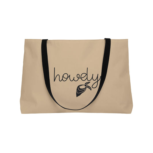 Beige tote bag with 'howdy' and a fish graphic on a white background