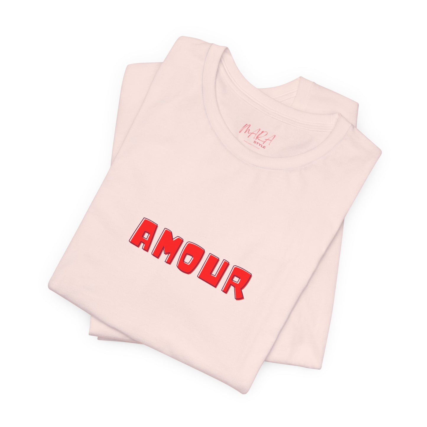 Folded pink tshirt with 'AMOUR' printed in red on a white background