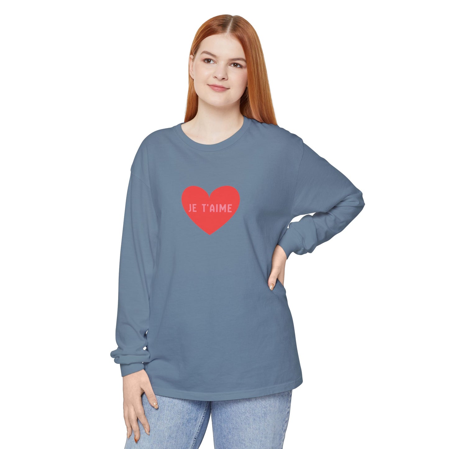 Woman wearing a blue long-sleeve shirt with a red heart and text on a white background