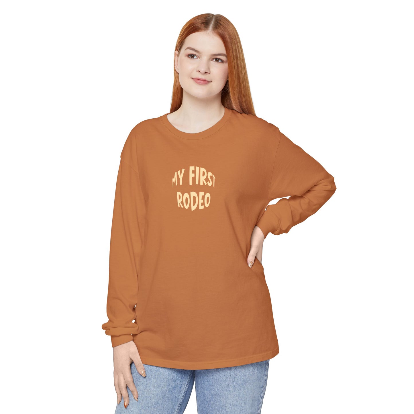 Person wearing a brown long-sleeve shirt with 'My First Rodeo' text on a white background