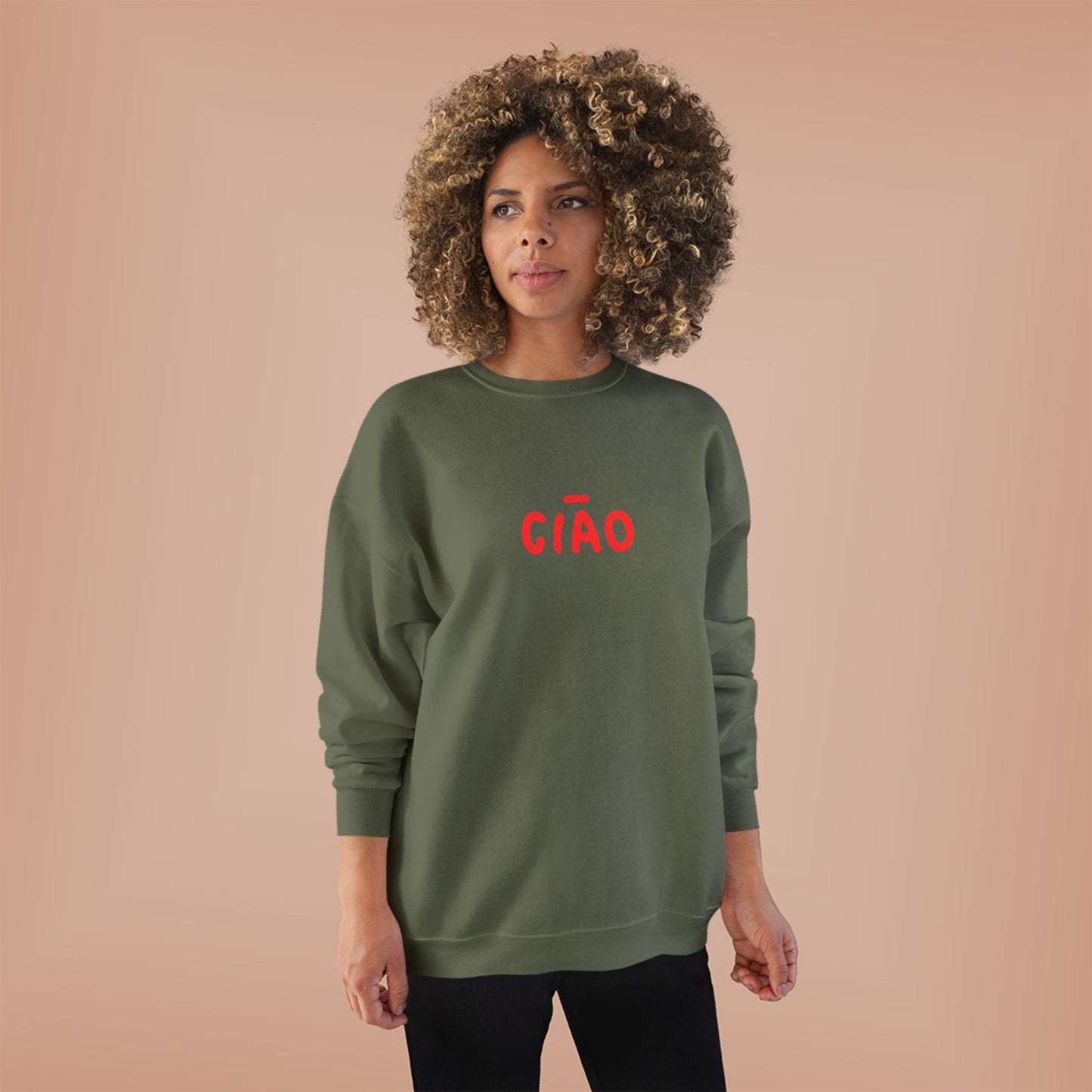 Woman wearing a green sweatshirt with 'CIAO' in red on a beige background