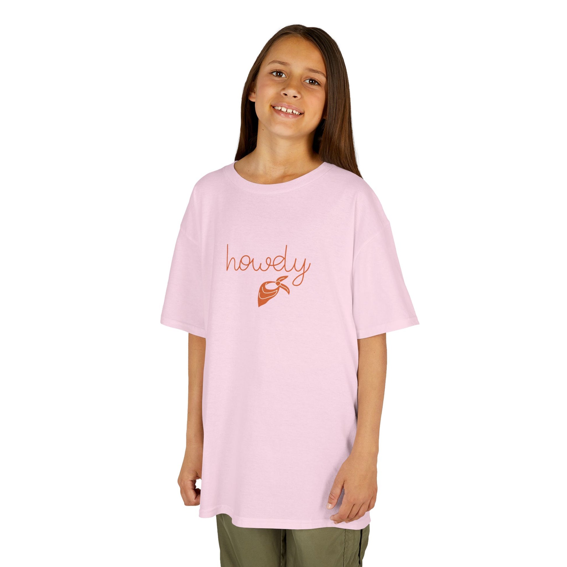 Young girl wearing a pink t-shirt with 'howly' printed on it against a white background
