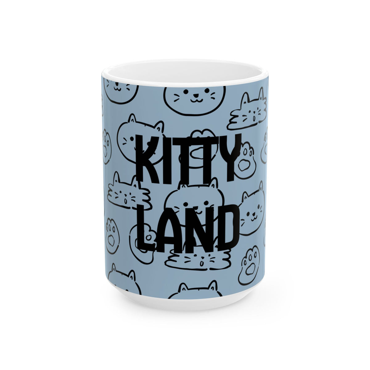 A white ceramic mug featuring a light blue wraparound print with a repeating pattern of cute black line-art cat faces and the words 'KITTY LAND' in bold black lettering.