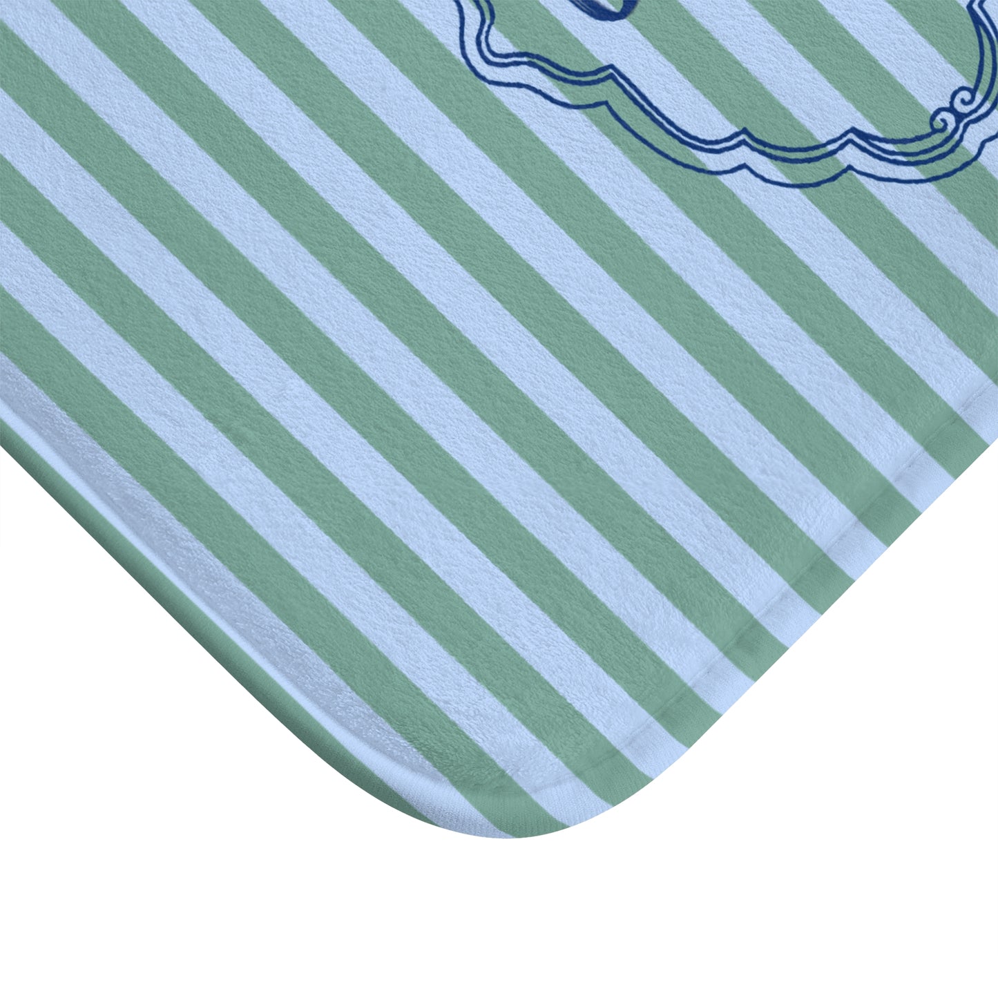Close-up of a green and white striped fabric with a decorative border.