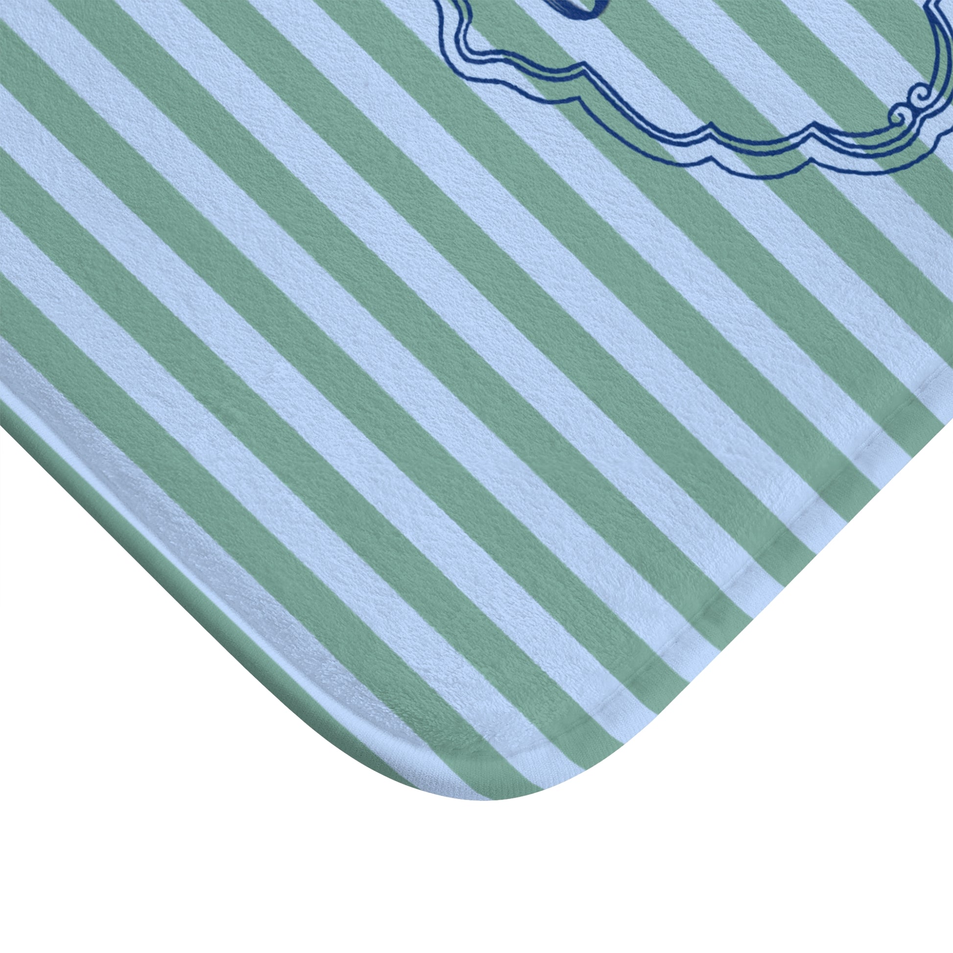 Close-up of a green and white striped fabric with a decorative border.