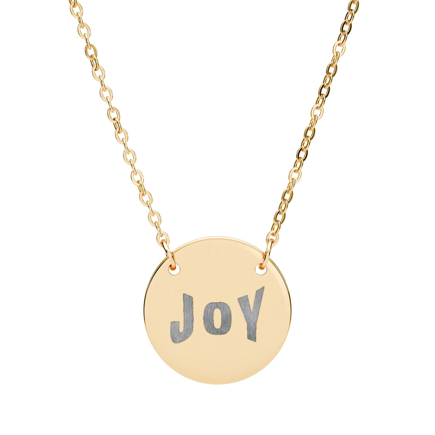 Gold necklace with a round pendant engraved with 'JOY' on a white background