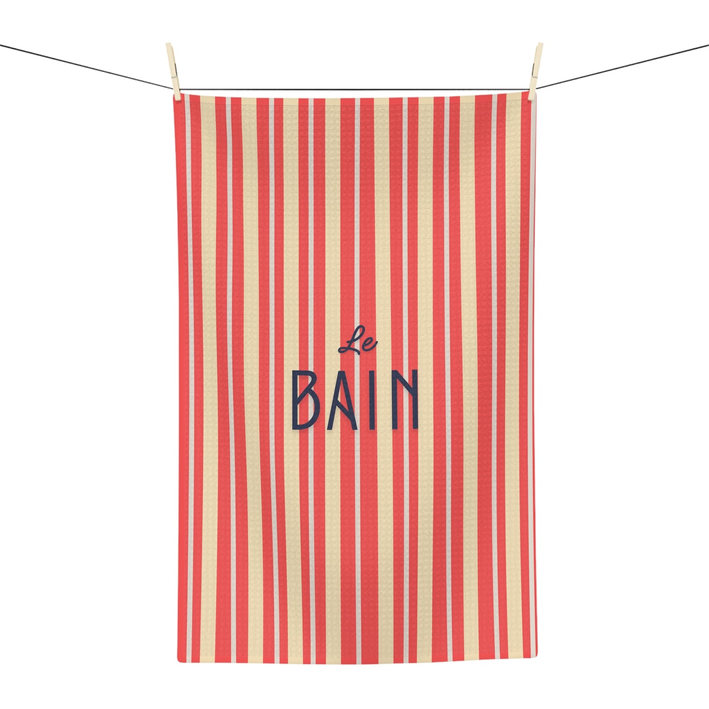 Striped towel with 'Le Bain' text on a white background