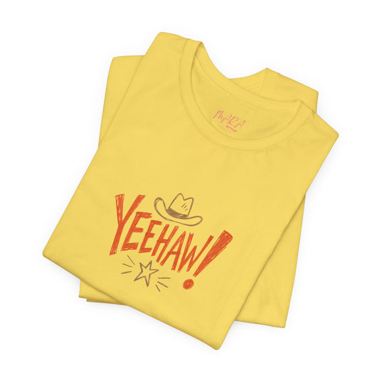 A folded yellow t-shirt with a retro-style 'YEEHAW!' graphic in red and brown, featuring a cowboy hat and starburst, on a white background.