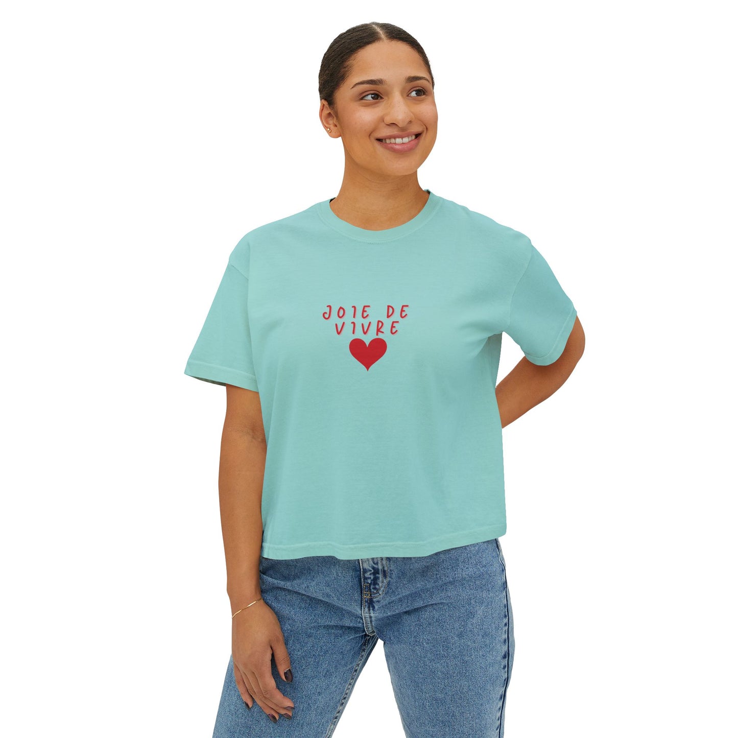 Person wearing a light blue t-shirt with 'Joie de Vivre' text and red heart on a white background