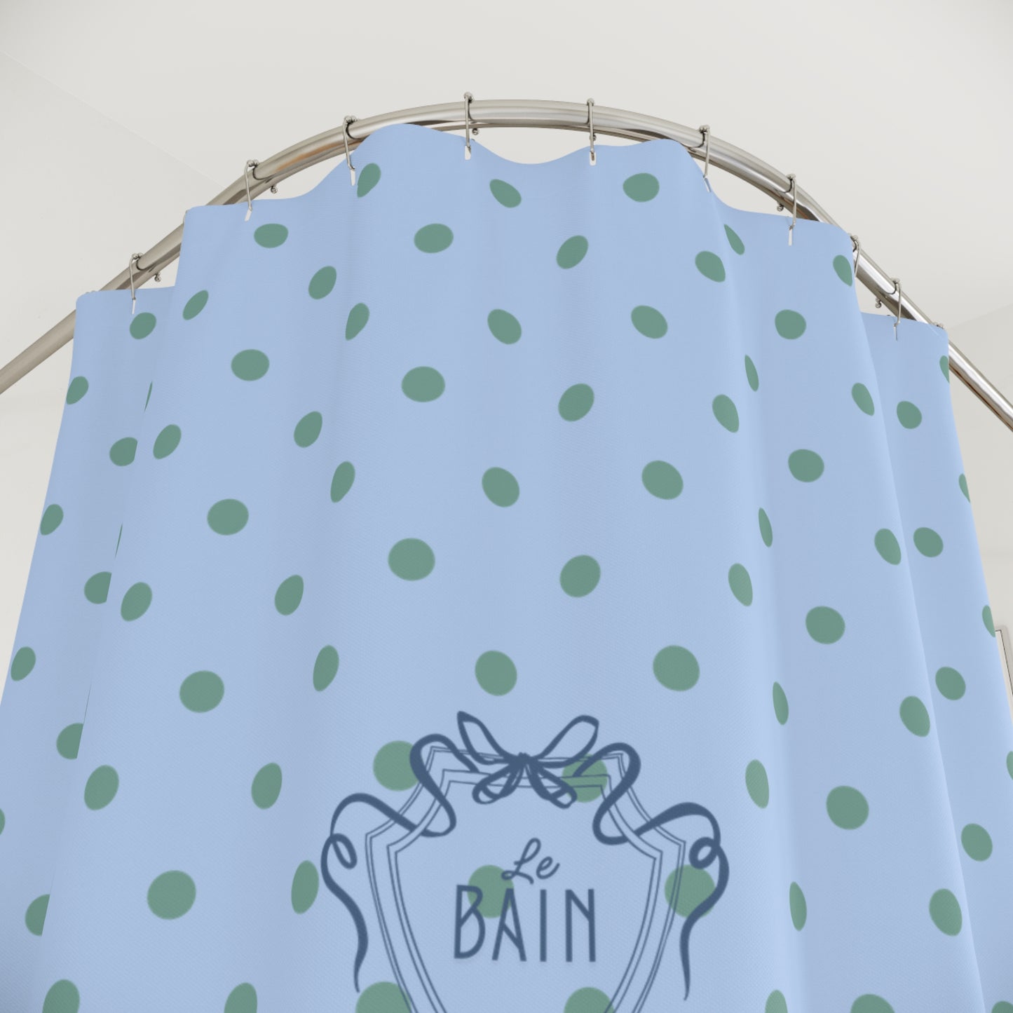 Light blue dress with green polka dots and 'Le Bain' logo on a hanger.