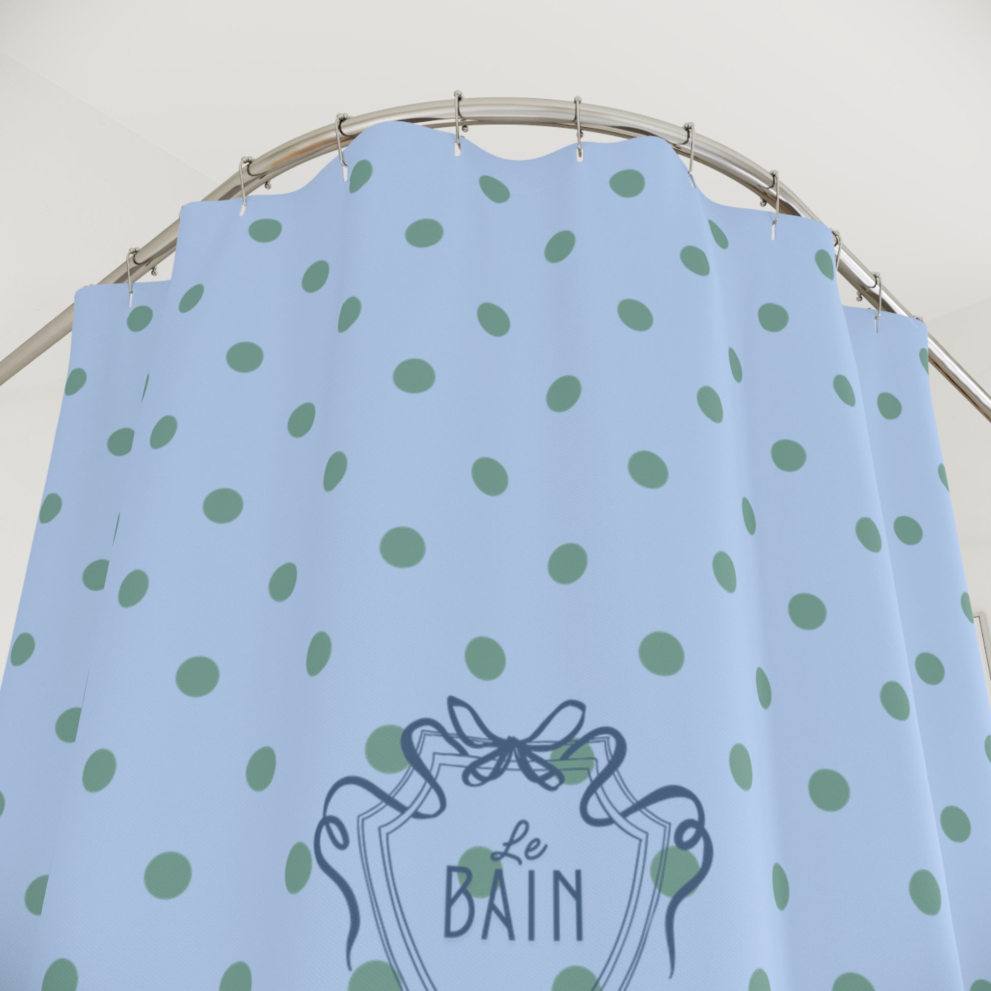 Light blue dress with green polka dots and 'Le Bain' logo on a hanger.