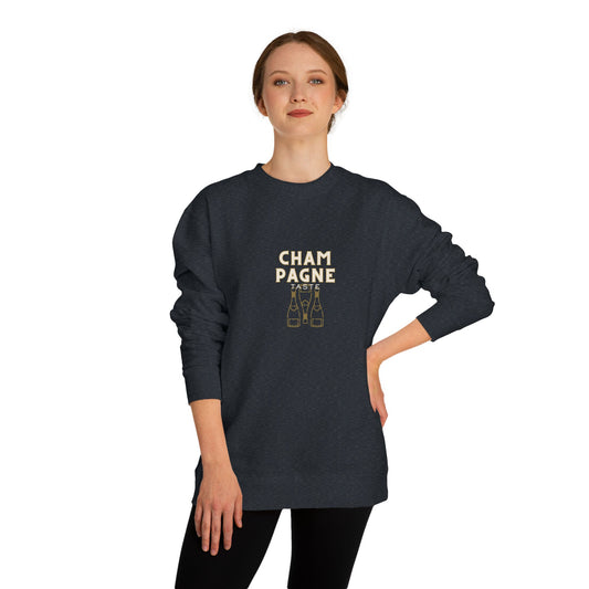 Person wearing a dark blue sweatshirt with 'Champagne' text and bottle graphics on a white background