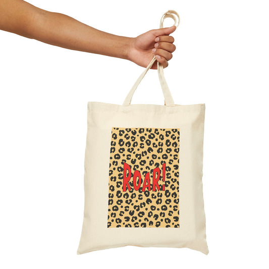 Tote bag with leopard print and 'ROAR!' text held by a hand on a white background