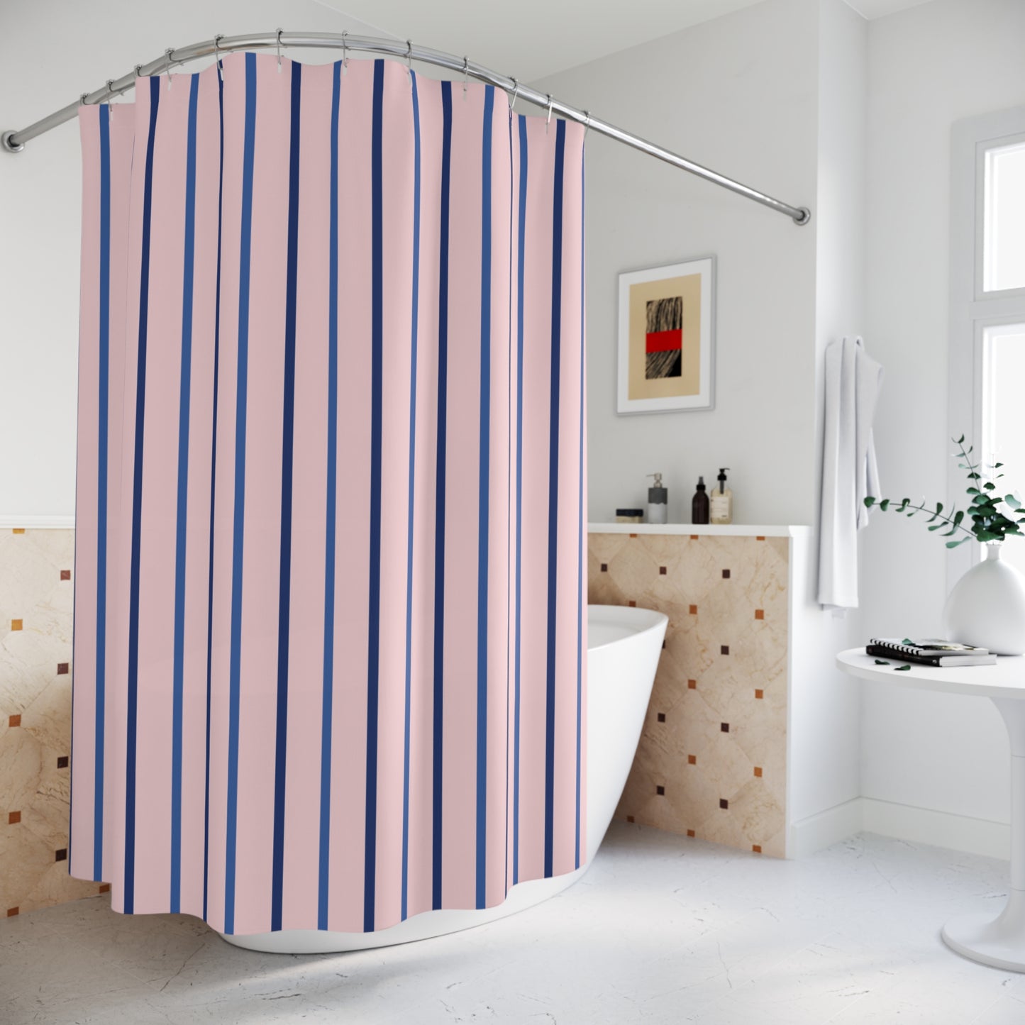 A pink and navy blue vertically striped shower curtain hanging in a bright, modern white bathroom with a freestanding bathtub and tiled wall.