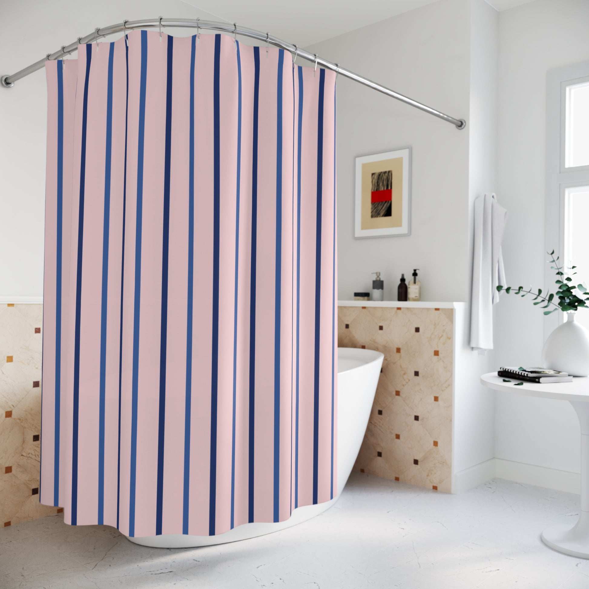 A pink and navy blue vertically striped shower curtain hanging in a bright, modern white bathroom with a freestanding bathtub and tiled wall.