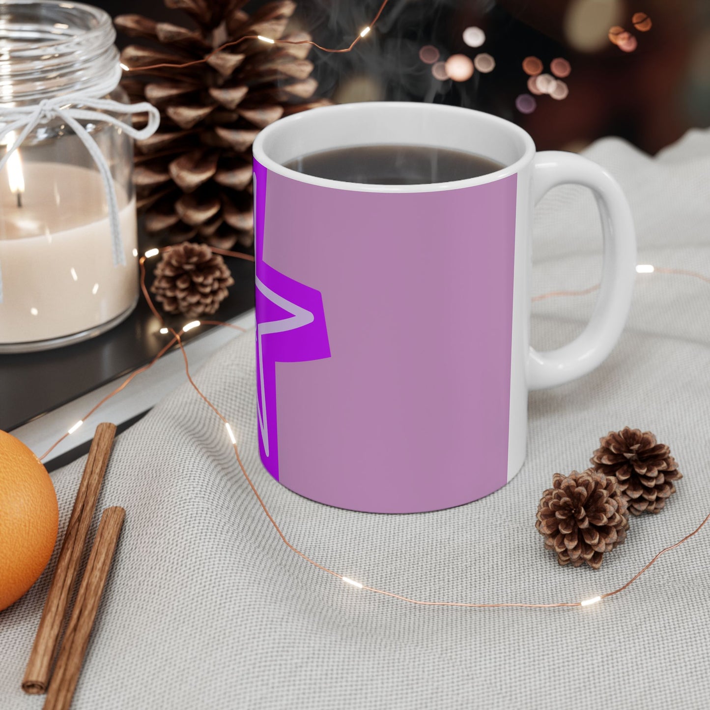 Purple mug with a white handle on a table with decorative items