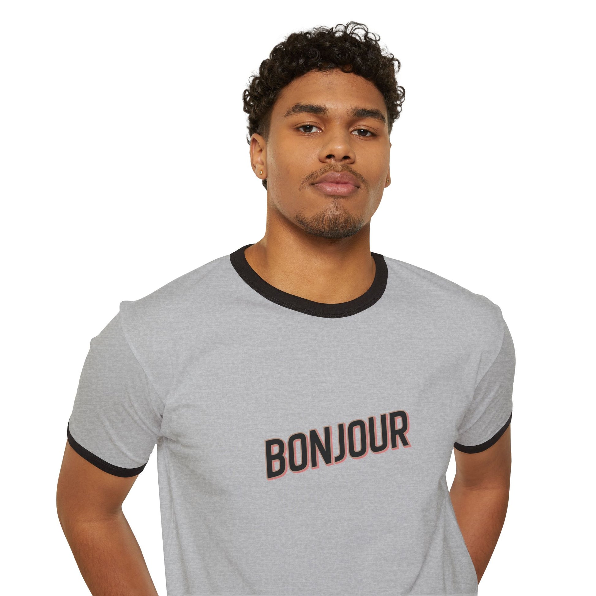 Man wearing a gray t-shirt with 'Bonjour' text on a white background