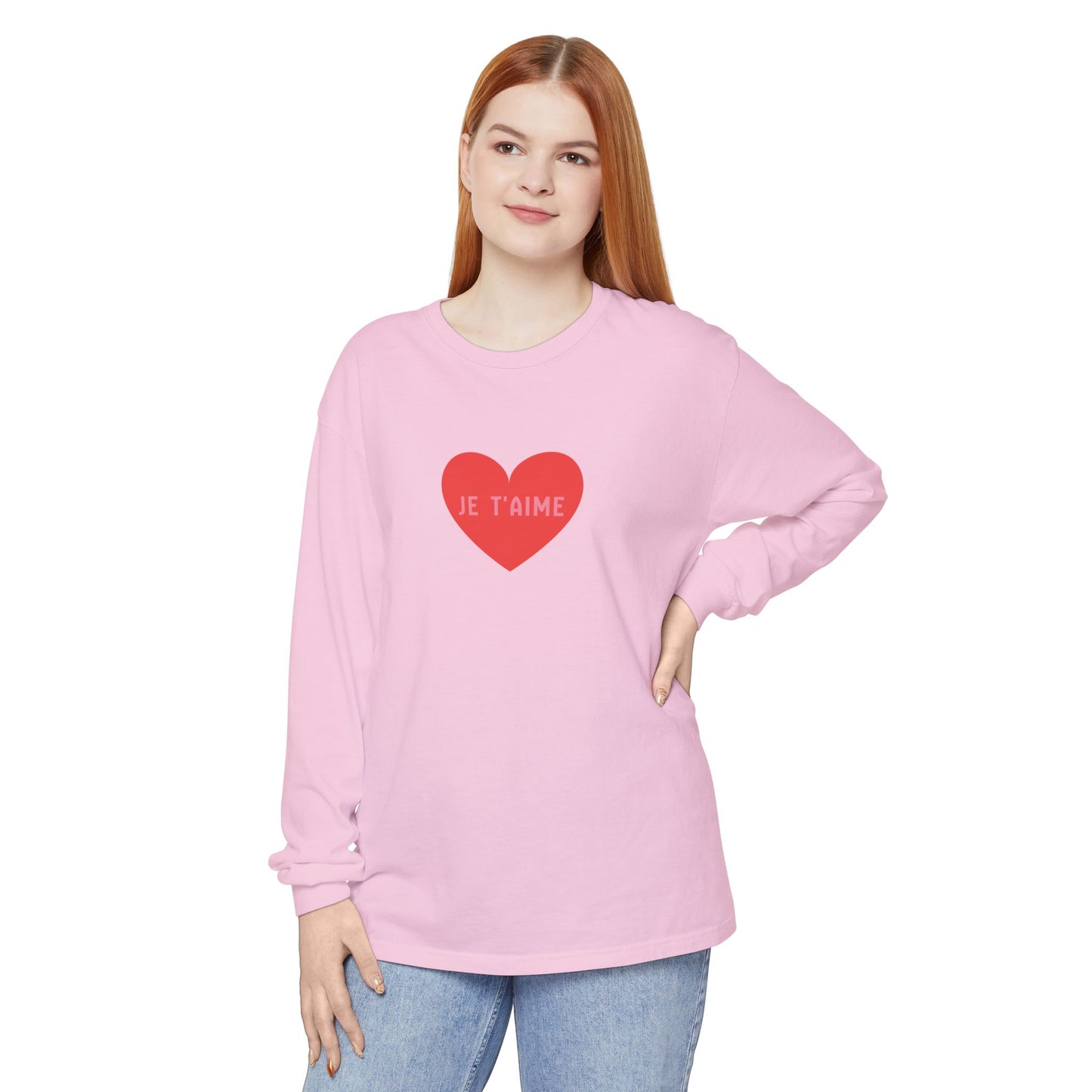 Person wearing a pink sweatshirt with a red heart and text on a white background