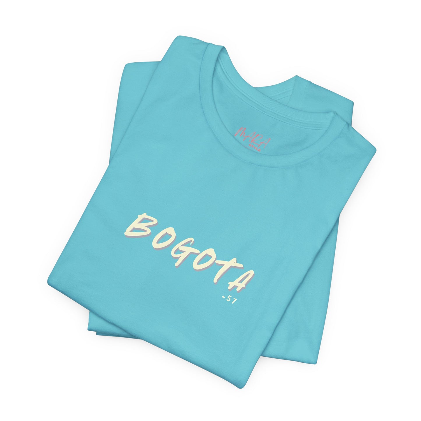 Stack of light blue t-shirts with 'BOGOTA' printed on them against a white background